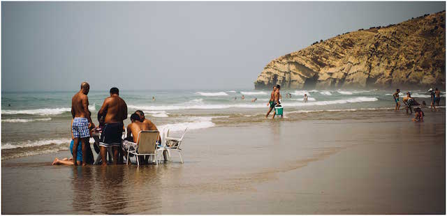 Men sitting together Paradise Beach Asilah Morocco