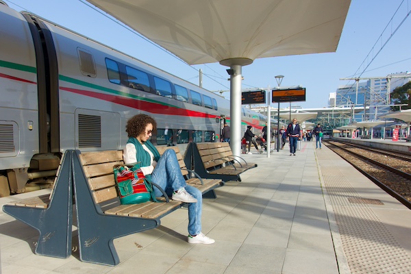 A woman waits for the al-boraq high speed train outside under cover in the Tangier train station alongside the Mediterranean. photo by Lucas Peters. Model Amina Lahbabi
