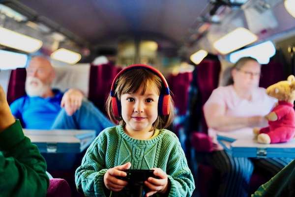 A young girl listens to music and plays with her father's Sony RX100 mark 7 camera on the Al-Boraq high speed train from Tangier to Rabat